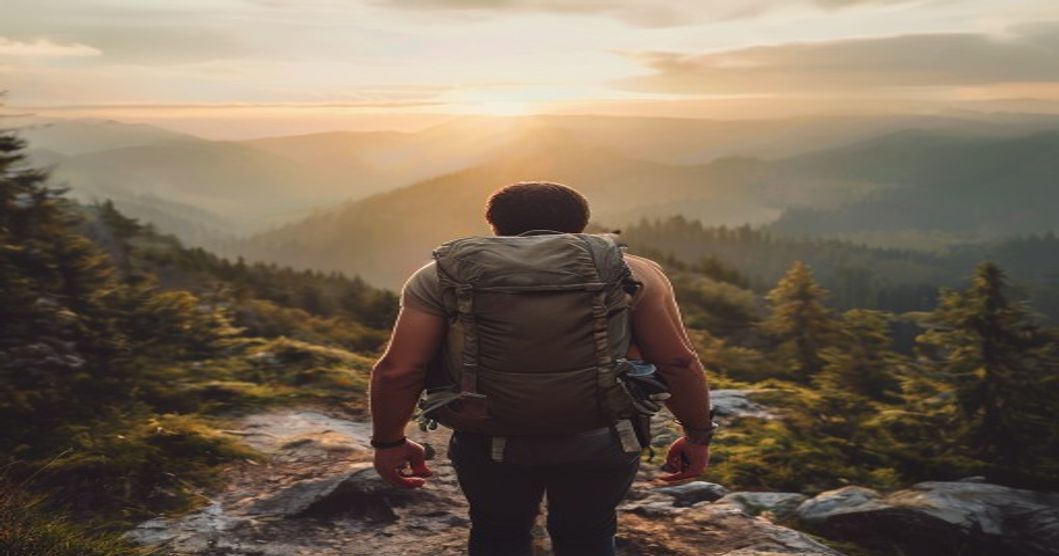 Hiker wearing a curved-strap travel backpack on a mountain trail during long-distance trek